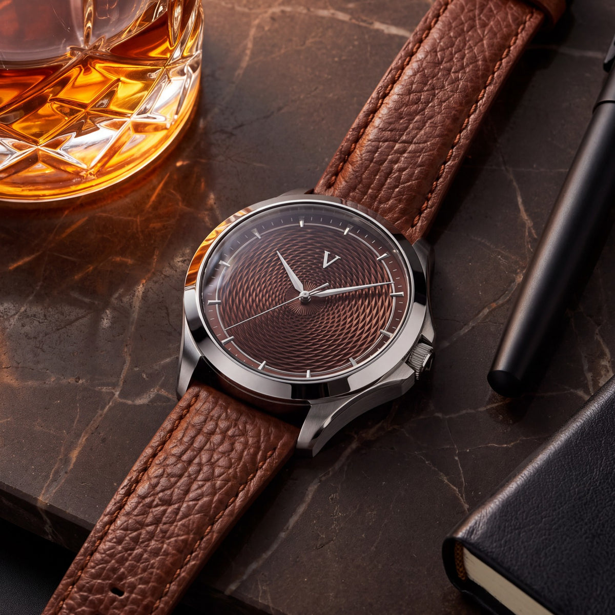 VALUSIS Velturion Brown guilloché dial watch on a brown leather strap beside a glass of whisky